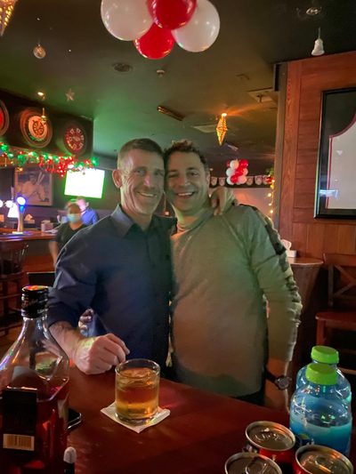 Jimi Gill with a friend in a bar.