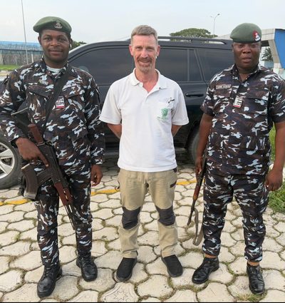 Standing between two Nigerian police officers.