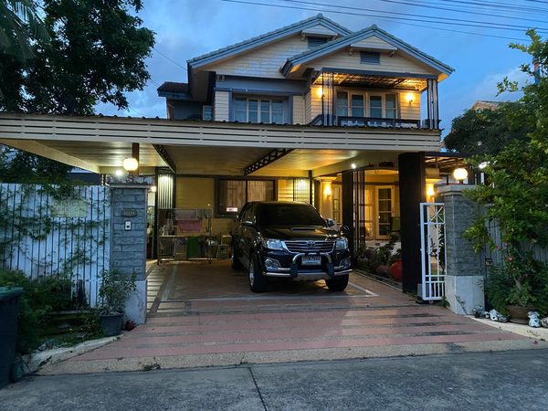 A house at dusk in Thailand, a Celtic Park nameplate on the gate.